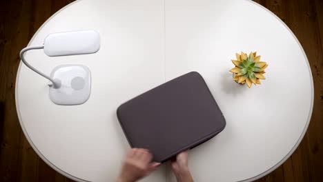 woman freelancer opens a laptop bag, pulls it out and works. chroma key. top view. hands close up view