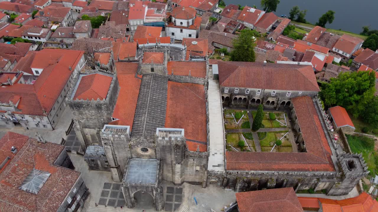 4K drone cinematic orbit around Tui Cathedral in Galicia, Spain, stunning aerial view of medieval architecture and historic town with panoramic perspective