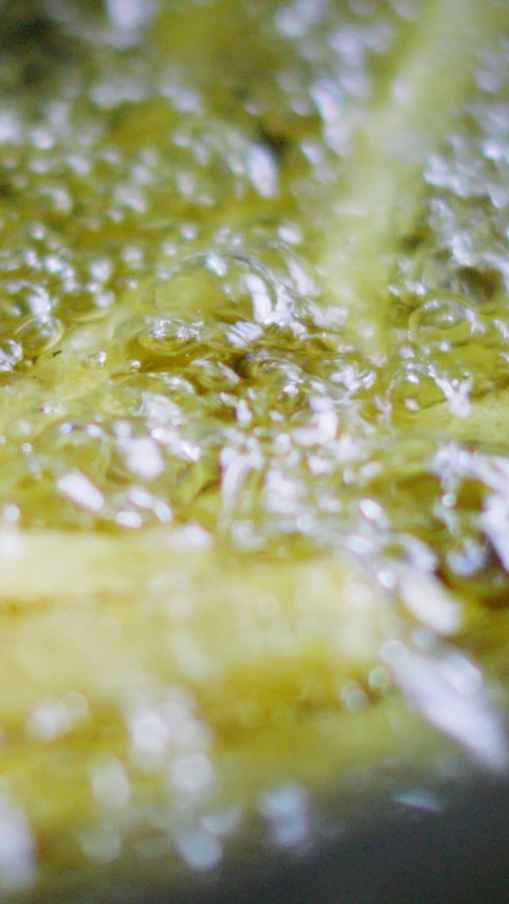 Vertical Video Slow Motion Close Up of French Fries in Deep Fat Fryer with Bubbles. Chips Frying in Hot Oil. Crispy Tasty Fast Food for Quick Dinner or Lunch