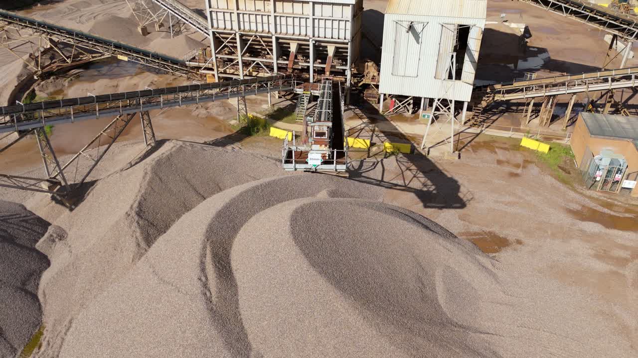 High altitude drone video of quarry site with gravel sorting conveyors and industrial machinery, Nottingham, United Kingdom