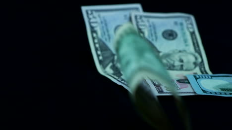 close up of falling dollar bills, studio shot