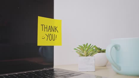 Young-Man-Leaving-Notes-Thank-You-On-Computer-Screen-At-Office