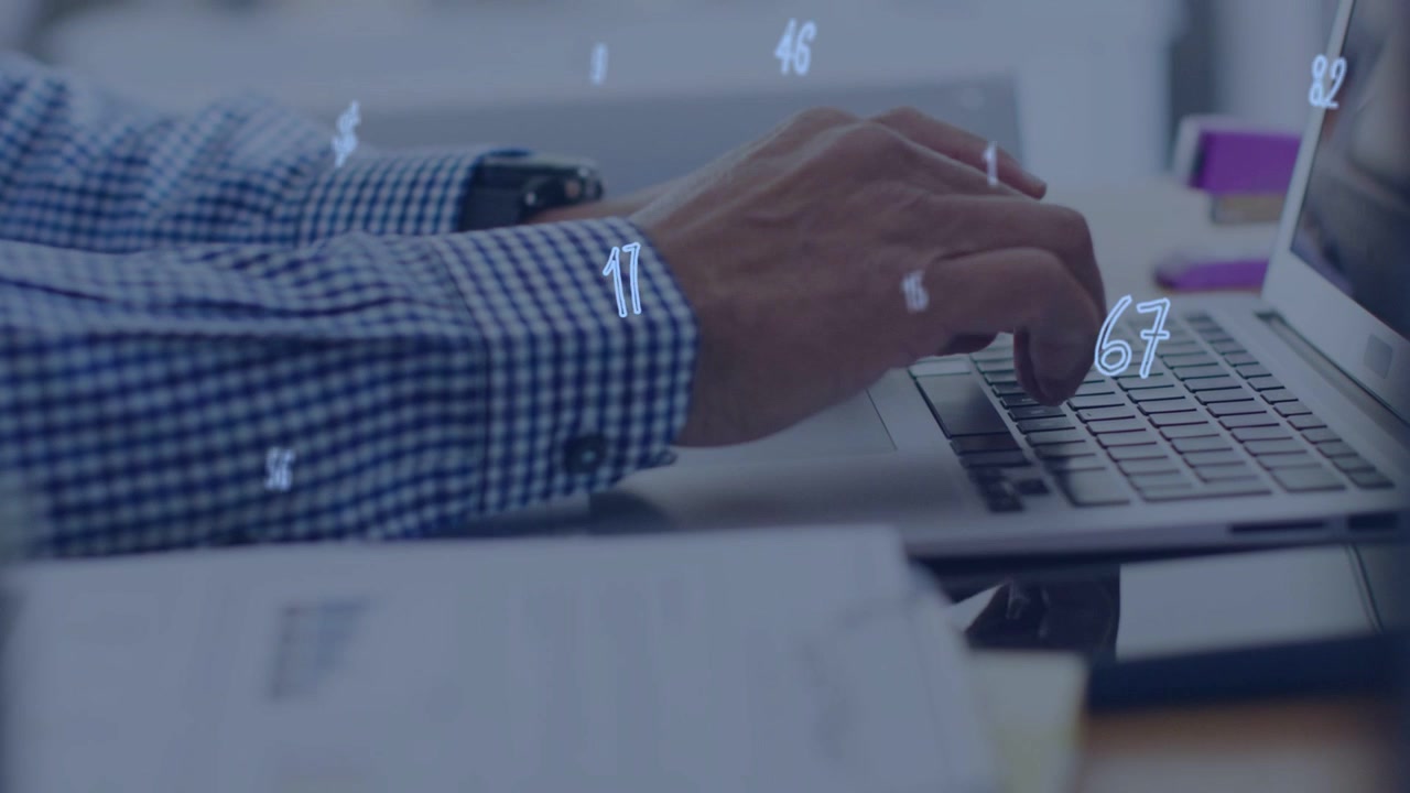 Office hands hovering above laptop keys starting typing with floating numbers aiding finance work