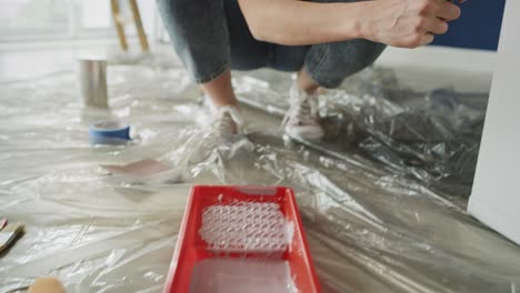 Video-of-woman-repainting-old-furnitures-with-a-roller.