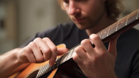 Man Playing Acoustic Guitar with Capo