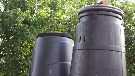 compost bins in a summer garden medium tilting shot