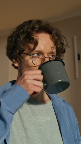 man drinking coffee at home