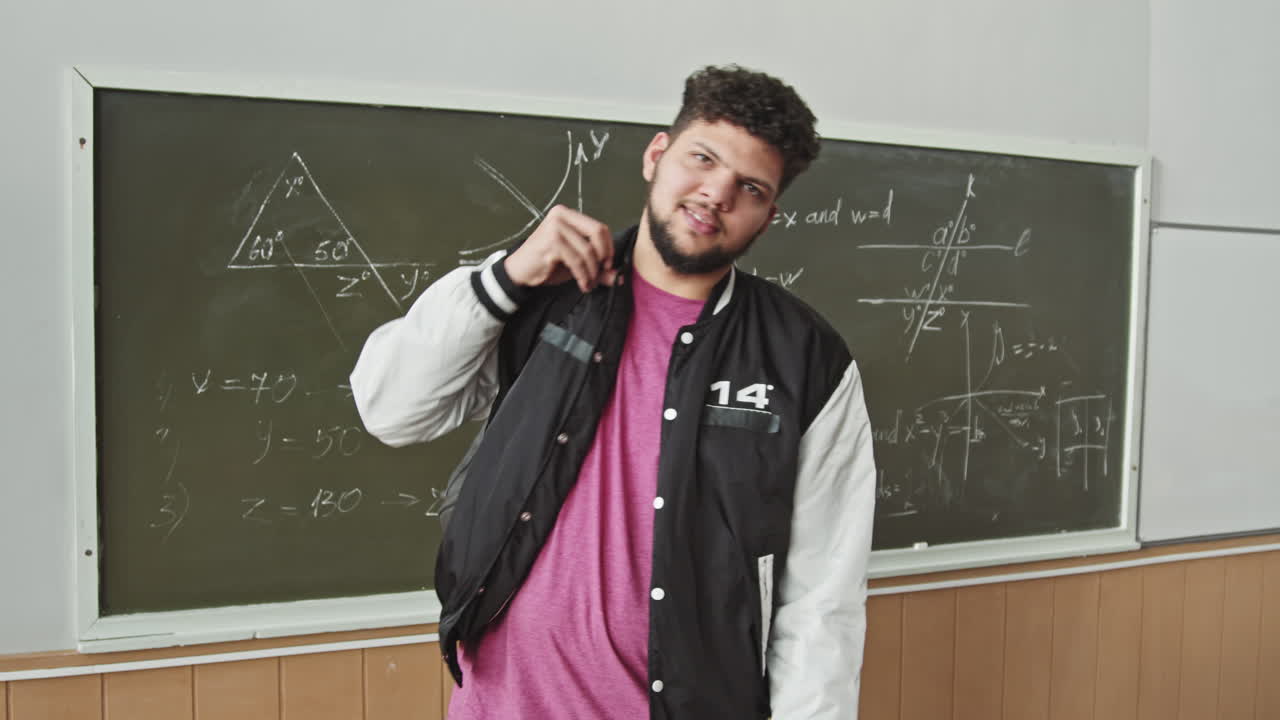 Portrait of Male Latin Student with Backpack at Blackboard