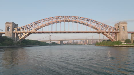 aerial view of the hell gate bridge, shot at sunrise in new york city