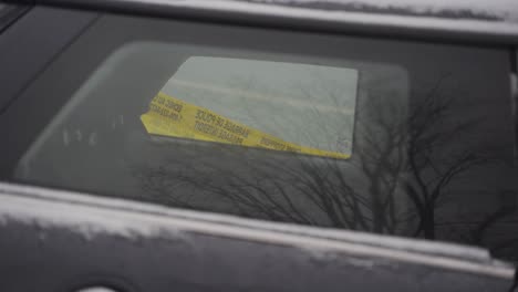 caution tape on the window of a car