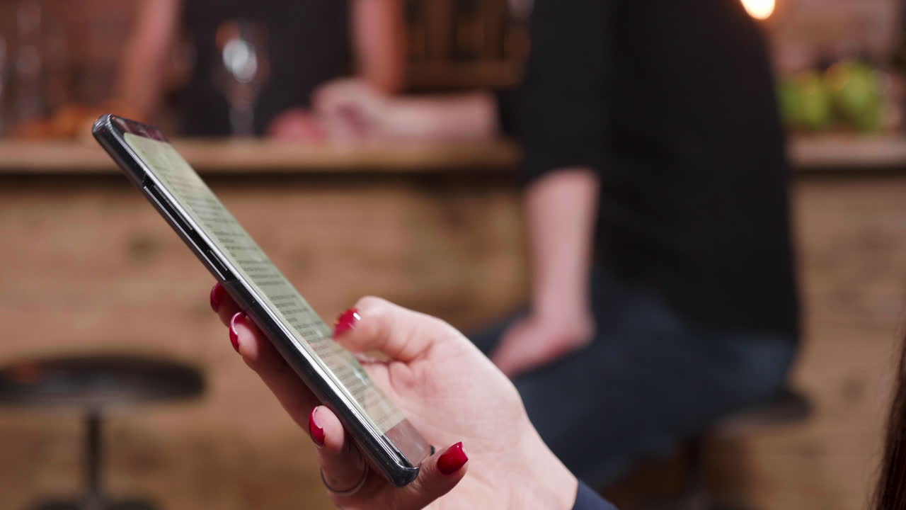 Person holding a smartphone in a bar