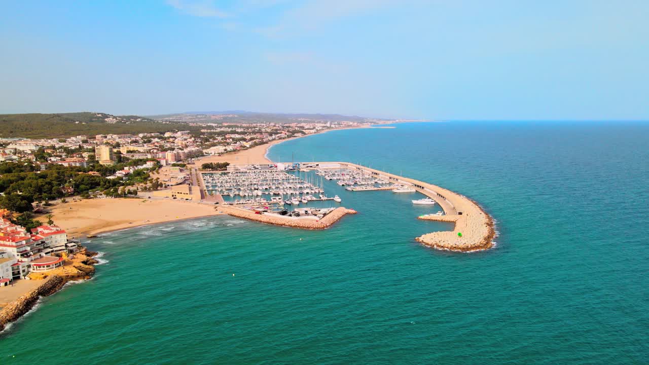 Aerial 4K drone footage of marina next to El Roc de Sant Gaiet&agrave;, a scenic location