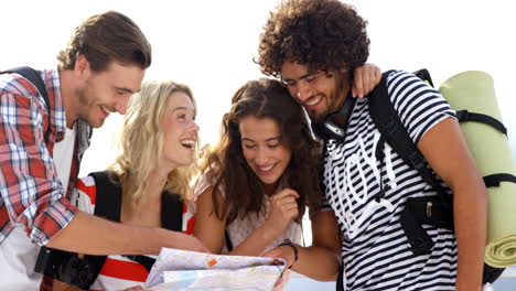 hipster group of friends looking at map together