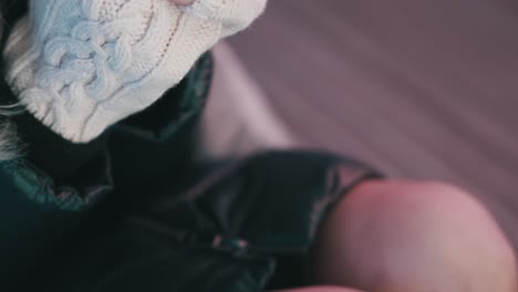 side-shot-of-model-wearing-coat-and-warming-her-hands