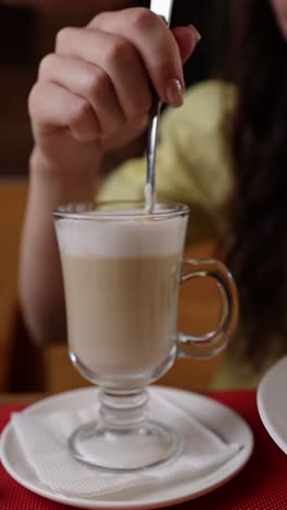 woman stirring a latte