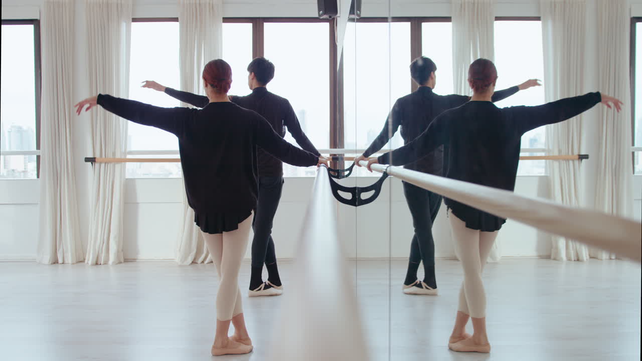Young Dancers Practicing Ballet at the Barre in a Studio