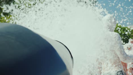 the gun fires the streams of foam on the crowd of tourists. foam party on the beach