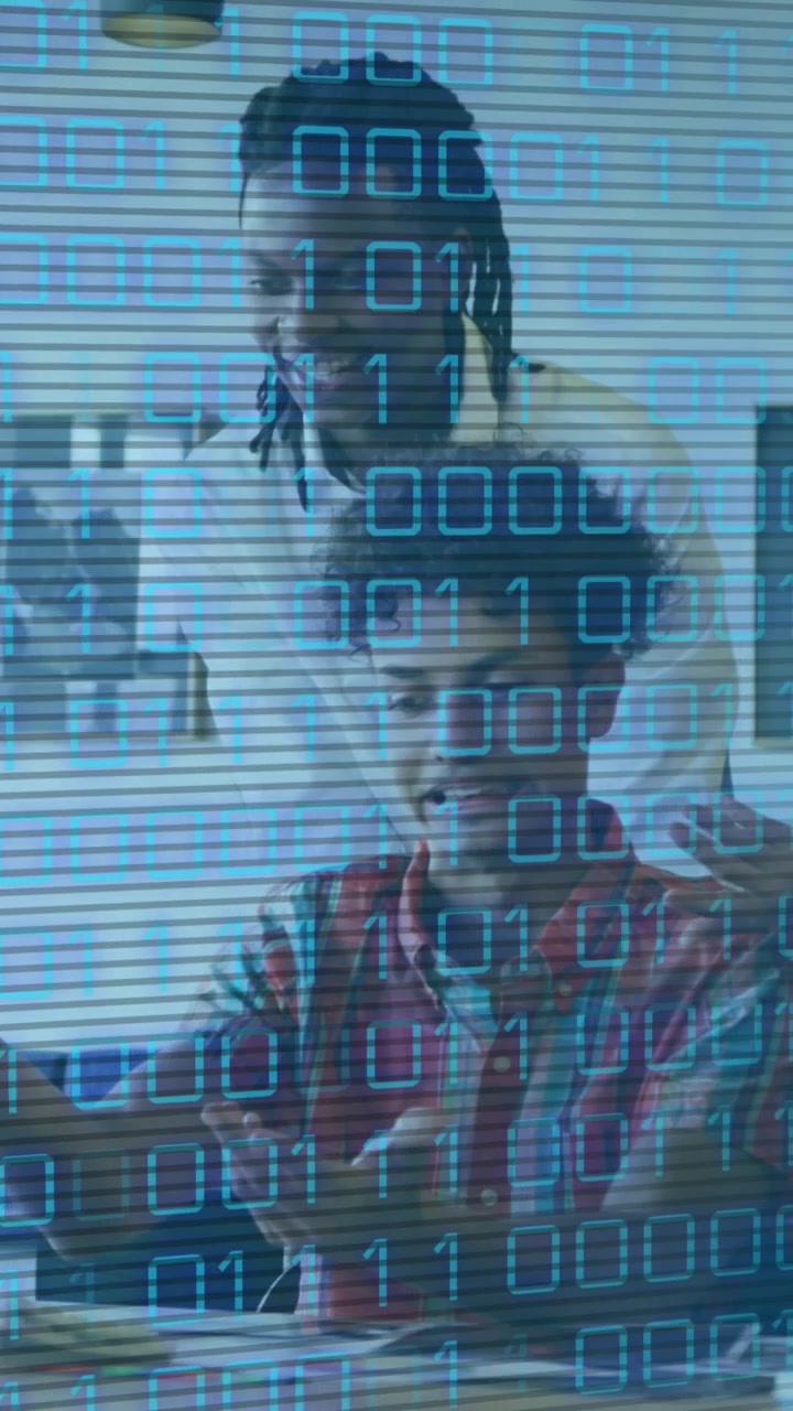 Animation of looping binary codes over diverse coworkers discussing reports on desktop in office