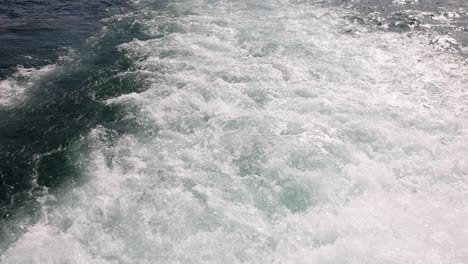 foamy wake of a boat on the water