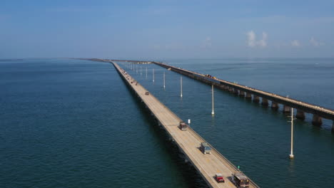 drone clip of dumptrucks driving down seven mile bridge near key west