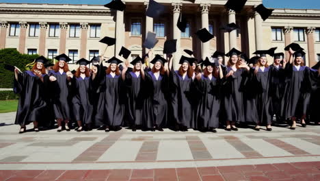 university graduates celebrate their success by throwing caps in the air