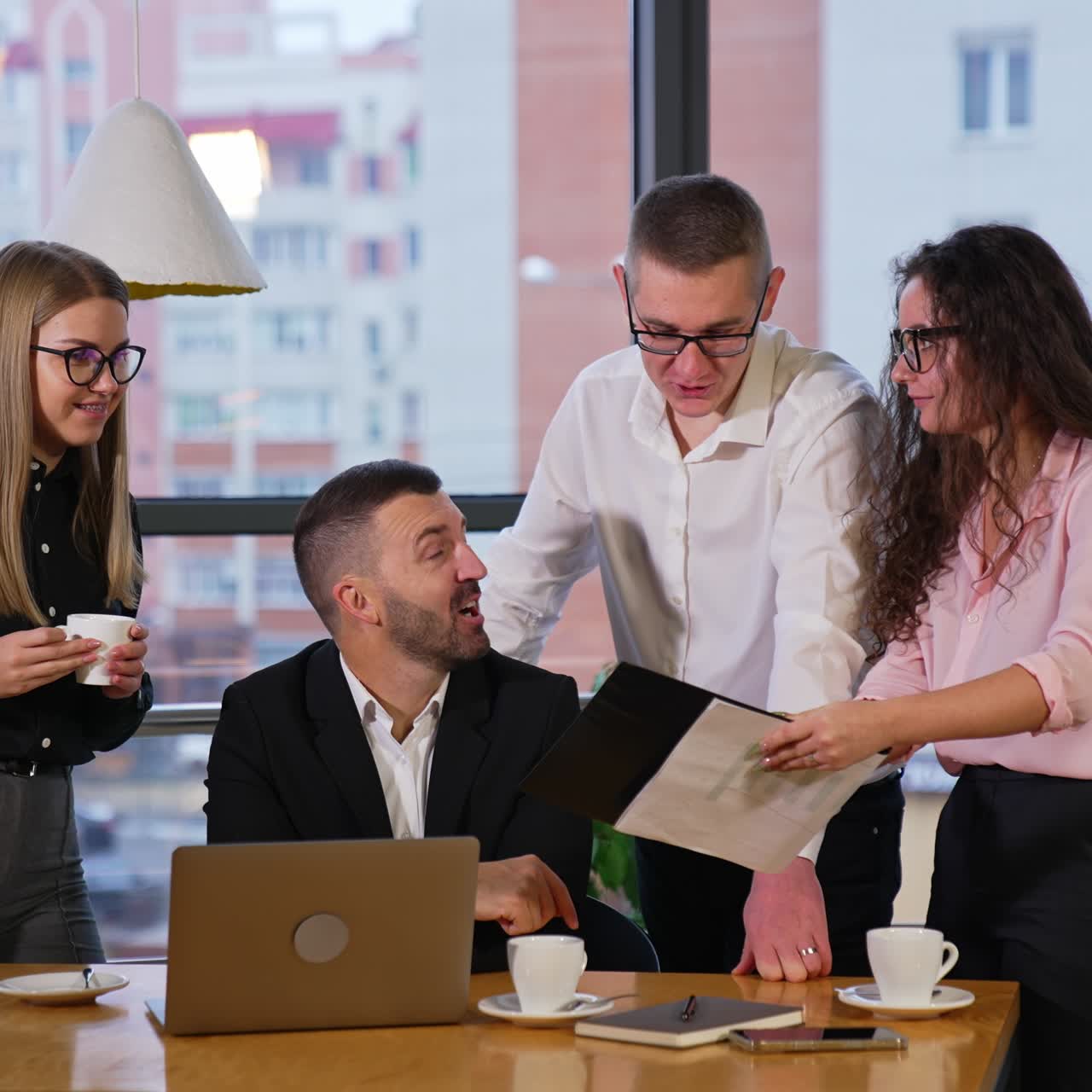 Business team of colleagues having discussion in office. Female employee shows her co-workers a document and people comment it