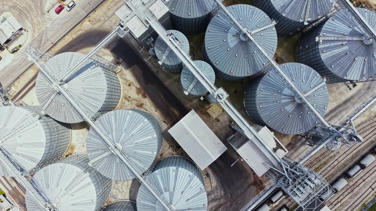 Aerial view of large storage silos in a grain facility at a farming location during daytime