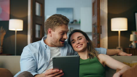 pareja riendo hablando tab llamada en la habitación de primer plano. abrazando pareja llamadas de video