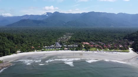 zoom-out-with-drone-on-a-paradisiacal-beach-on-the-north-coast-of-São-Paulo,-sunny-day-with-few-clouds