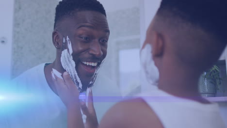 animation of lights over happy african american father and son shaving and having fun