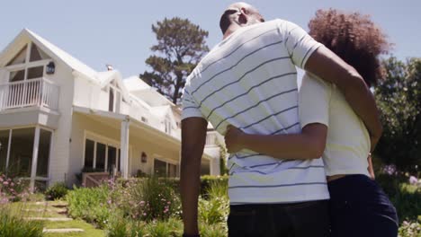 Happy-mixed-race-couple-enjoying-in-the-garden-during-a-sunny-day