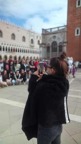 woman taking photos in st. mark's square, venice