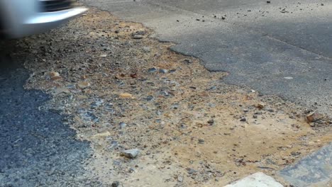 close up video footage of cars or vehicles travelling through a roadworks area in an asphalt road in the city