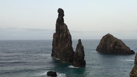 sharp rock formation in atlantic sea, coastline of madeira island, portugal, drone shot