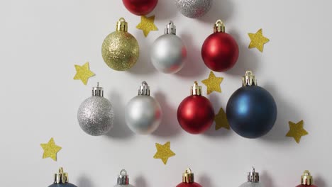 Video-of-christmas-decorations-with-baubles-and-copy-space-on-white-background