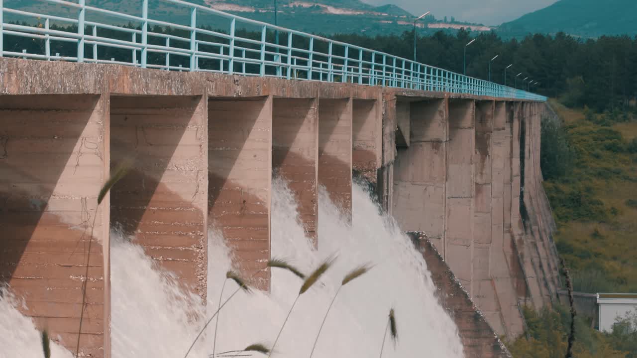 Water flowing through the floodgate of a dam producing sustainable renewable energy