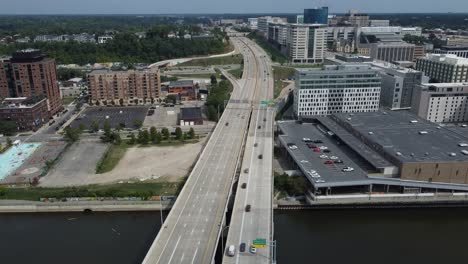 Traffic-Drives-Along-Two-Intersecting-Highways-Dividing-A-Metropolitan-City-With-Tall-Business-And-Residential-Buildings-And-Architecture