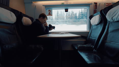 man stocker shooting landscape from moving train