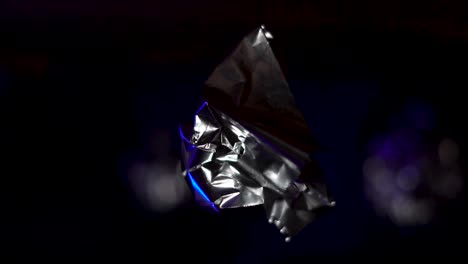 abstract metallic foil with blue light reflections