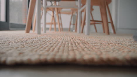 young male cleaning the house with a vacuum cleaner cleaning the carpet close up living room