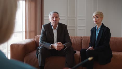 mature couple having consultation with professional psychologist in office