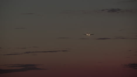 airplane landing at sunset