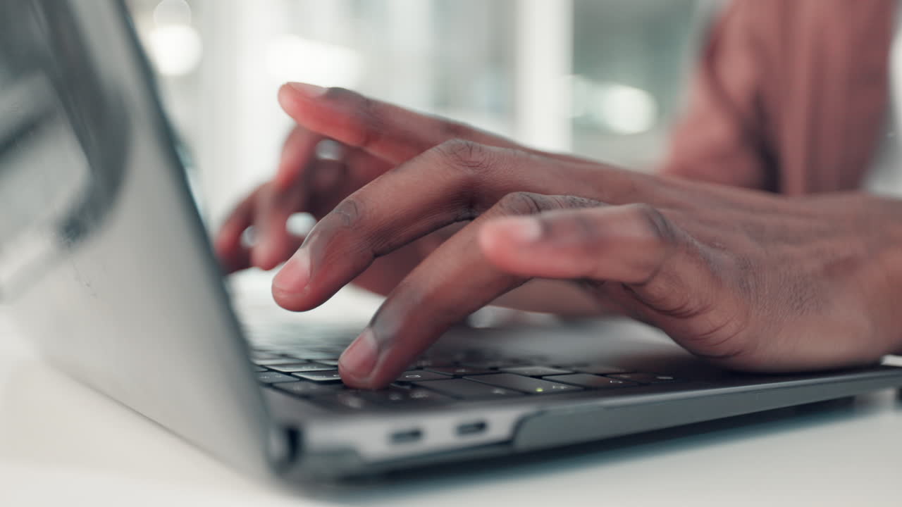 Hands Typing on a Laptop Keyboard