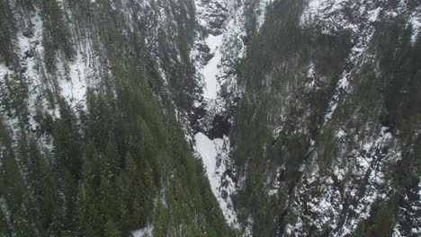 Cinematic-aerial-view-of-mountains-in-snow