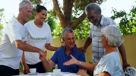 Happy-volunteers-shaking-hands-with-each-other-4k