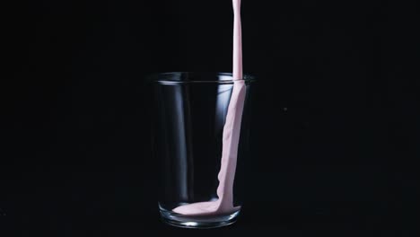 strawberry smoothie pouring into glass