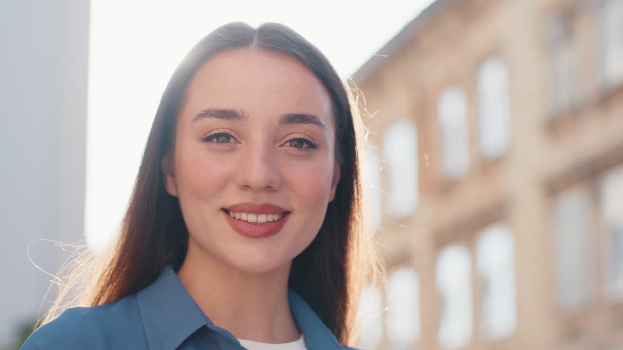Portrait of young pretty tourist woman walking in urban city street smiling with positive good mood