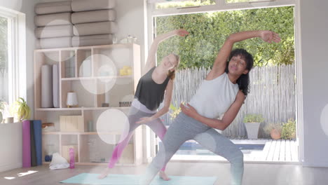 animation of white light spots over diverse teenage girls practicing yoga together