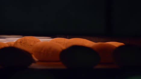 punch of hot bread come out of industrial oven inside bread factory