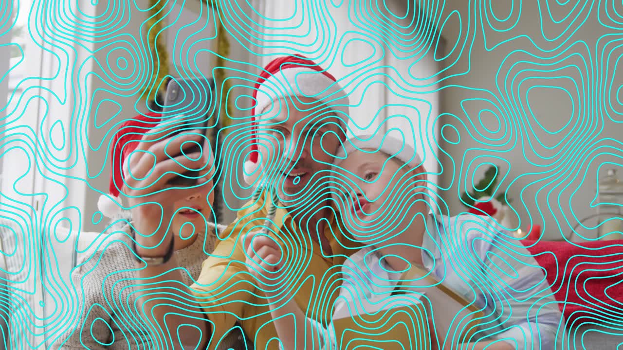 Animation of shapes over caucasian father and sons at christmas